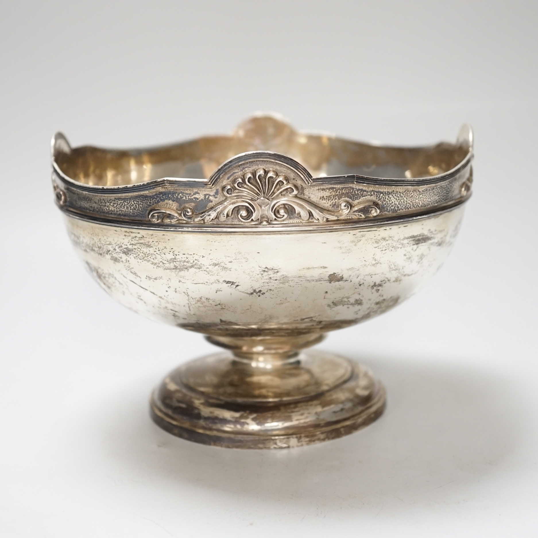 A George V silver rose bowl, with anthemion and scroll decorated rim, and 1918 presentation inscription, makers Garrard & Co., London 1913, diameter 18.5cm, 601 grams